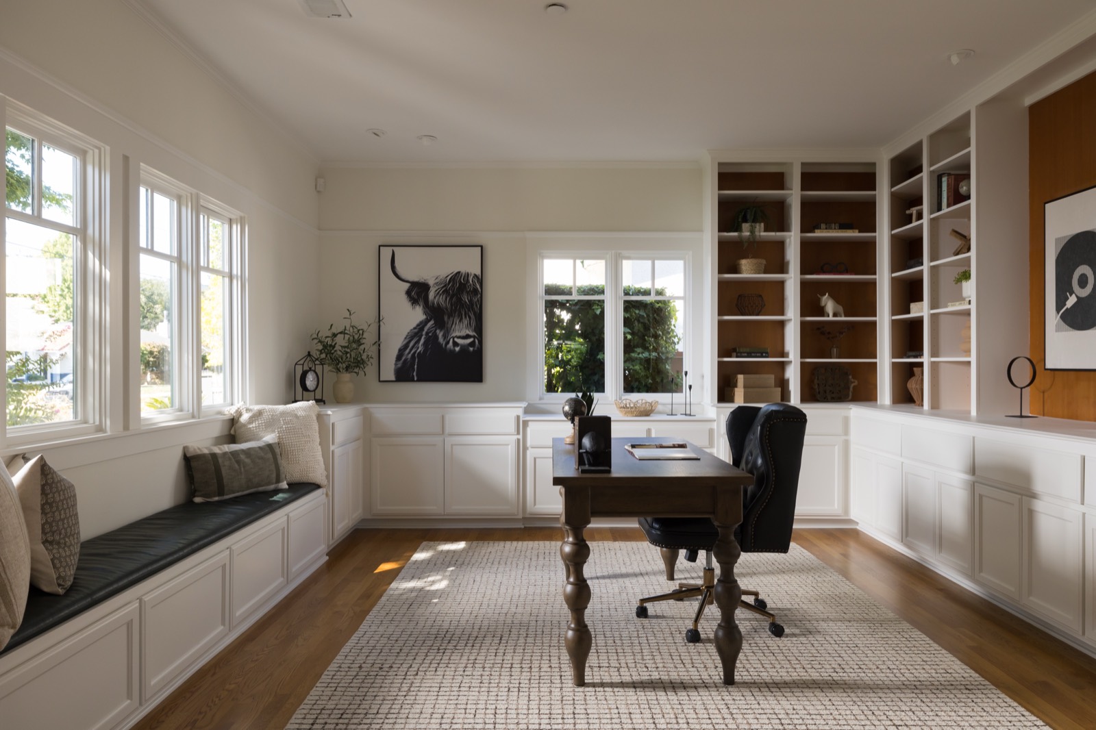 Office with built-in shelves and cabinets