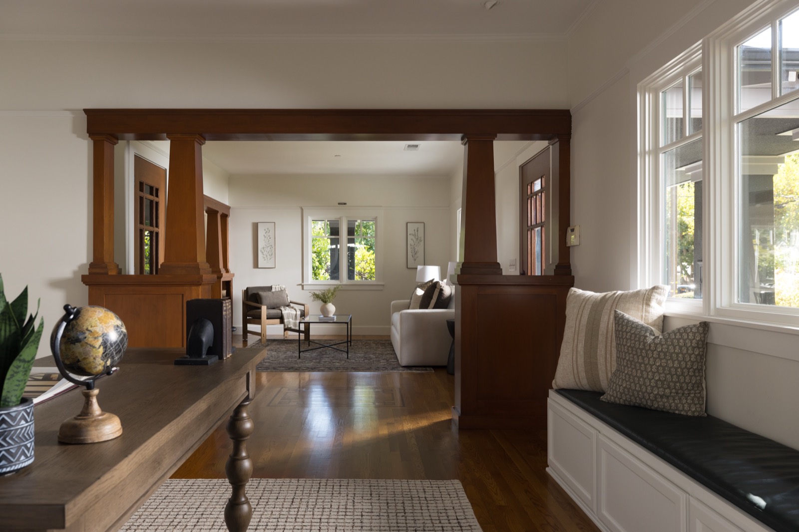 View from the office through wood Craftsman columns into the living room