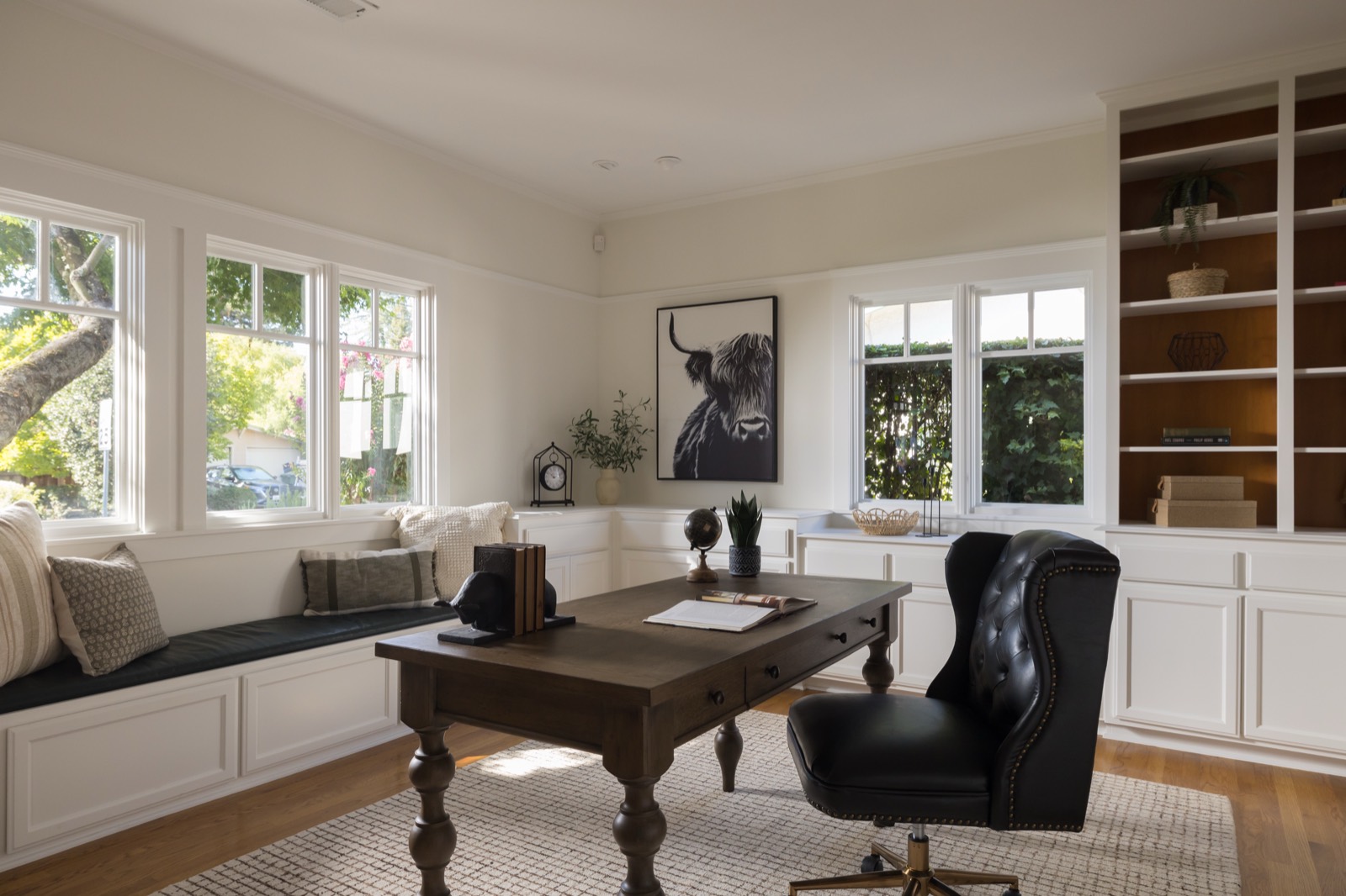 Office with built-in cabinetry, shelving and a window seat