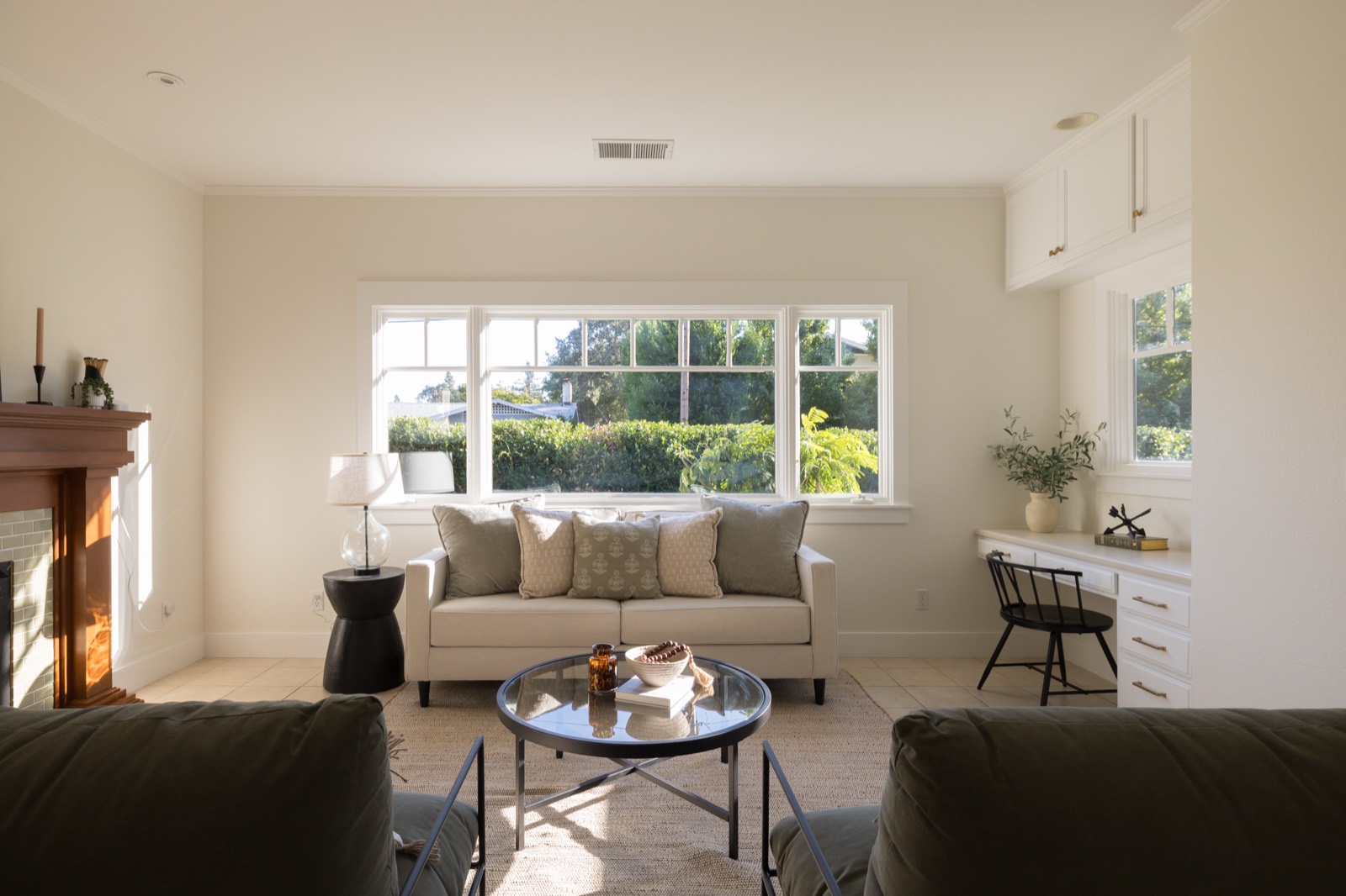 Family room with fireplace, a large window and a desk nook