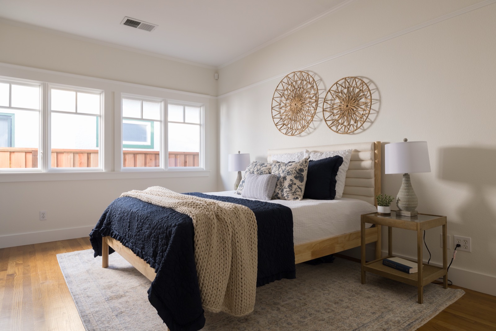 Second bedroom with oak floors and windows on two sides